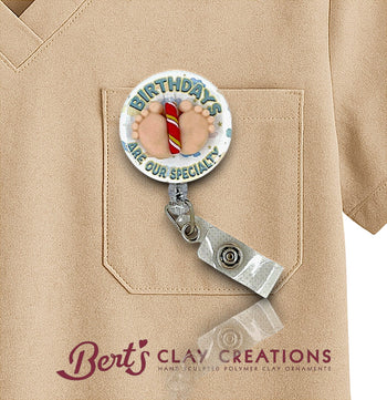Retractable badge holder with birthday design on a beige shirt, featuring 'Bert's Clay Creations' branding.